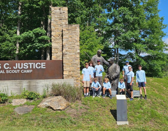Group photo of Scouts at camp logo