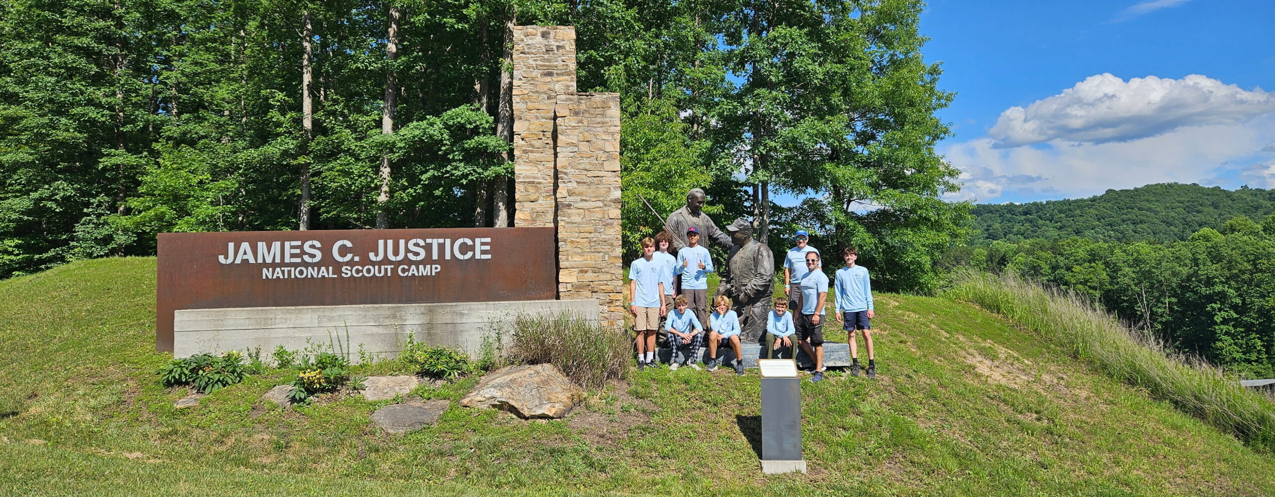 Group photo of Scouts at camp logo